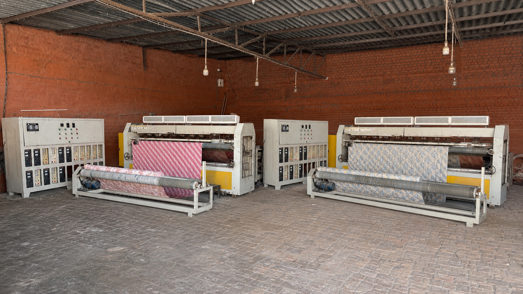 Ultrasonic quilting machines processing patterned textile on the factory floor